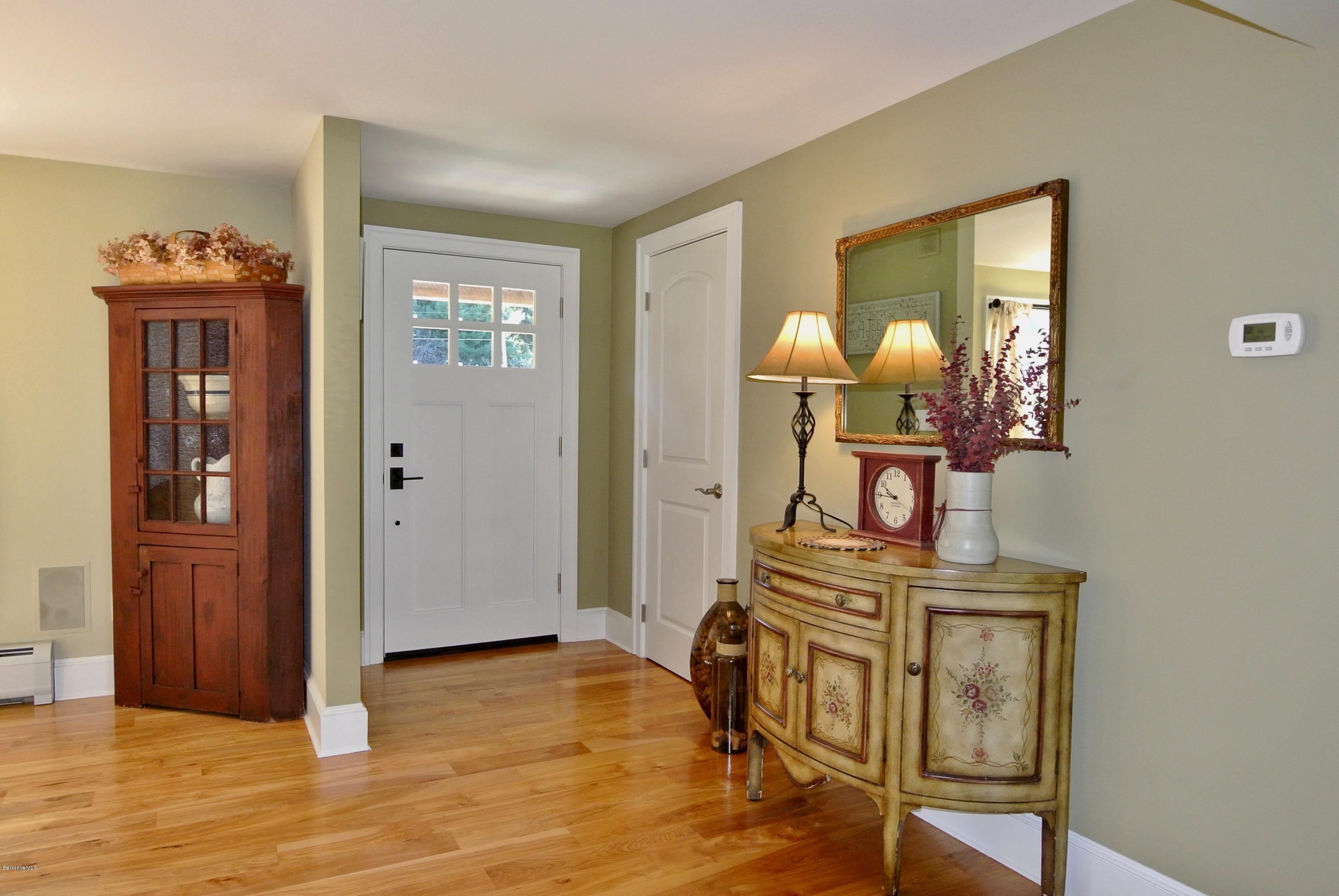 3136 State Road Richmond, MA 01254 - Photo 15 of 29 a view of a livingroom with furniture wooden floor cabinet and mirror