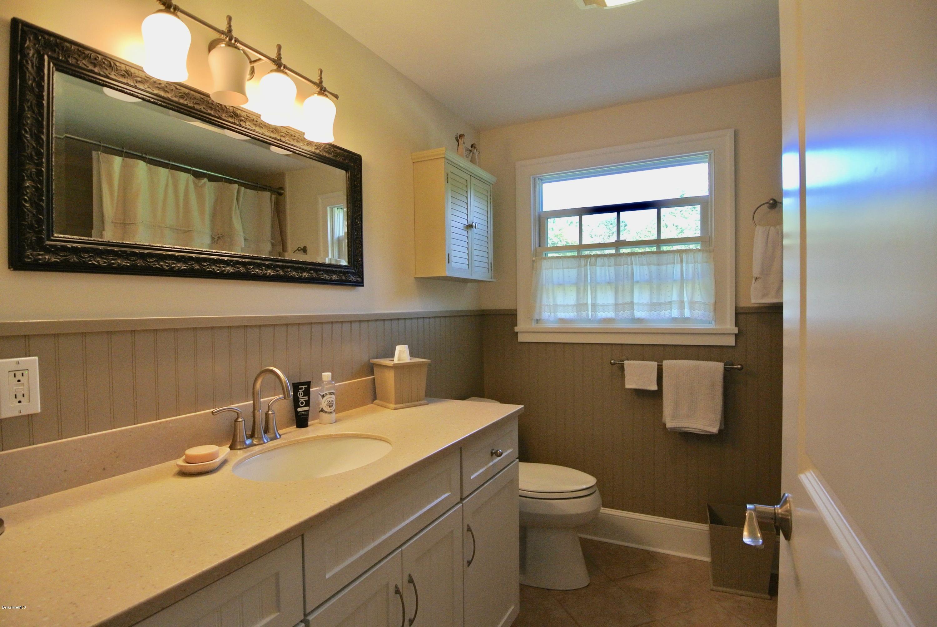 3136 State Road Richmond, MA 01254 - Photo 21 of 29 a bathroom with a toilet sink vanity and mirror