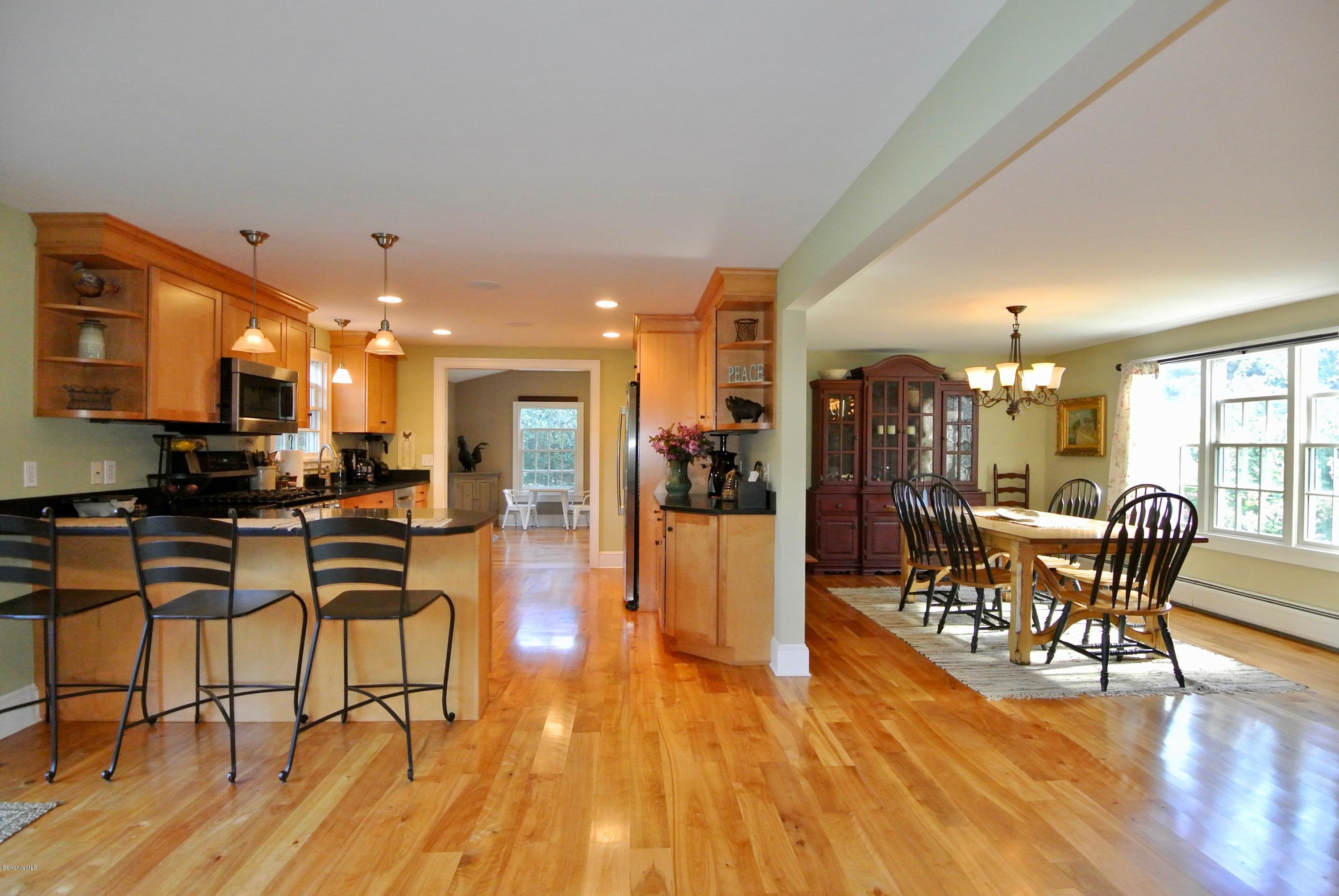 3136 State Road Richmond, MA 01254 - Photo 25 of 29 a dining room with furniture and wooden floor