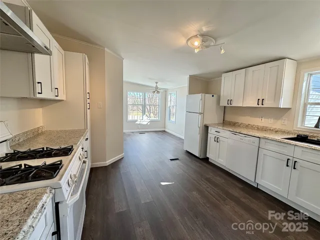 a kitchen with cabinets and a stove