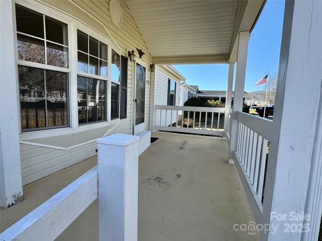 a view of a porch with wooden floor and fence
