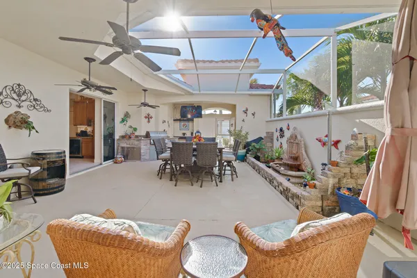 a living room with furniture and a view of kitchen
