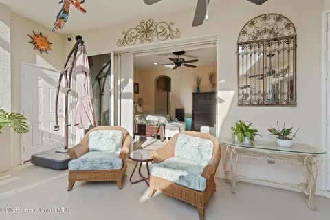a living room with furniture and a view of kitchen