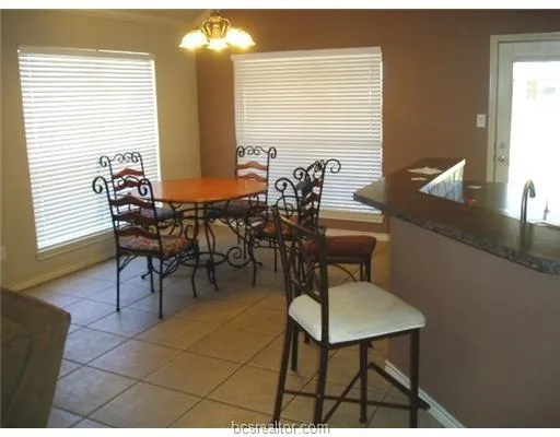 a view of a dining room with furniture and window