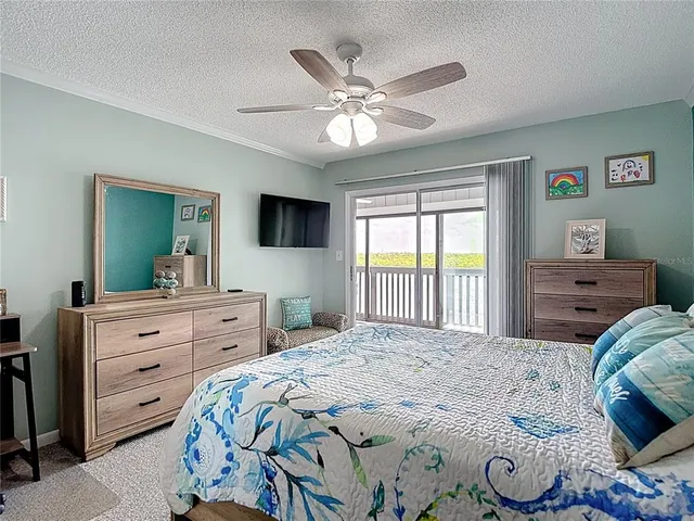 a view of a livingroom with furniture and floor to ceiling window