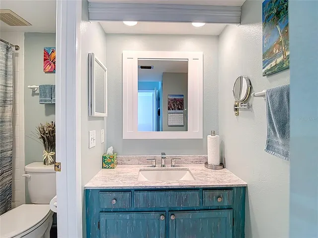 a view of a hallway with wooden cabinets