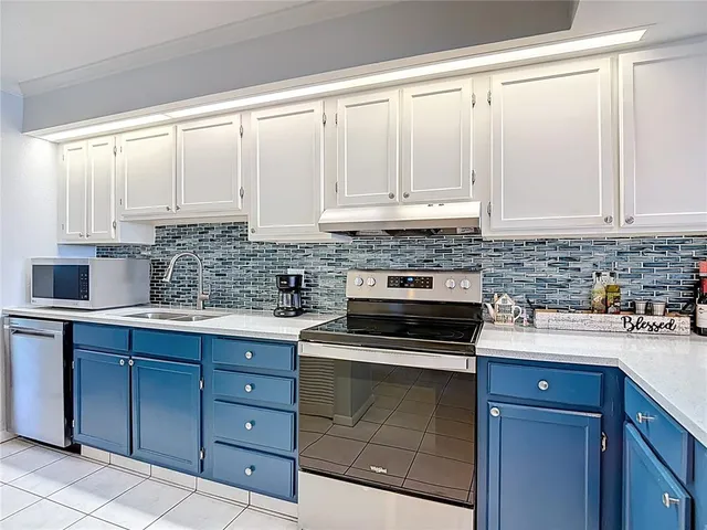a view of a kitchen with a sink and mirror