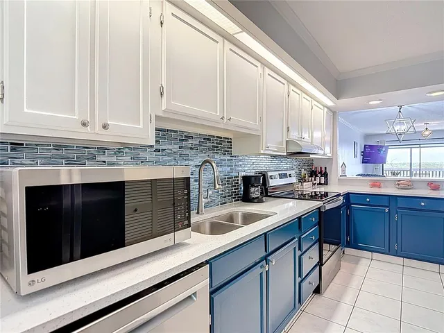 a dining room with furniture a chandelier and window