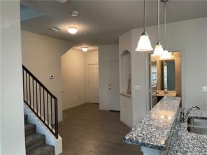 a view of a livingroom with furniture and stairs