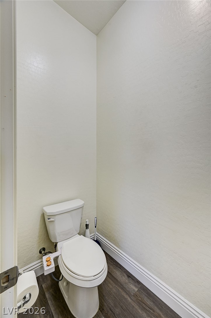 8197 Riley Love Street Las Vegas, NV 89139 - Photo 35 of 48 A well-appointed water closet with modern wood-look flooring.