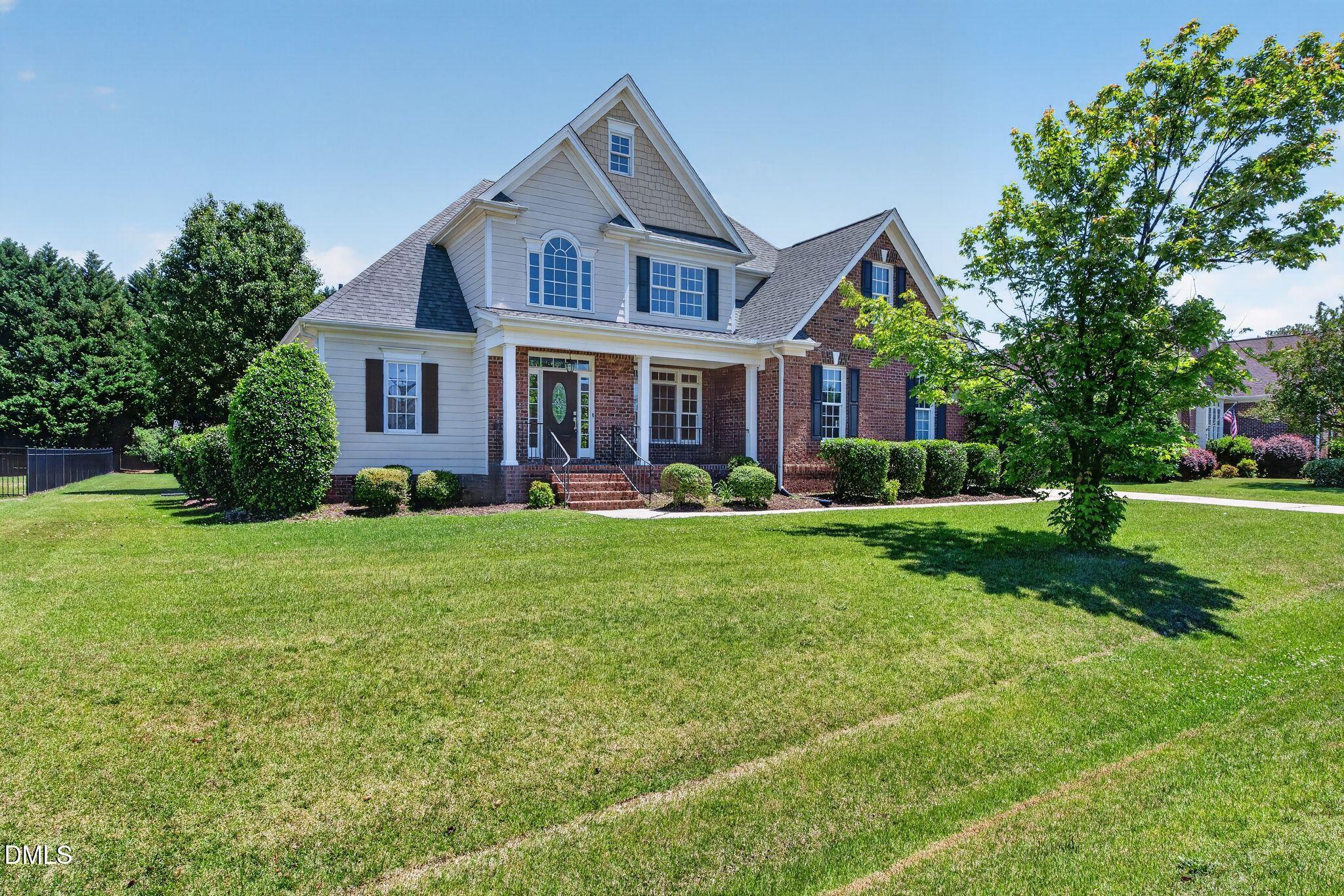 a front view of house with yard and green space