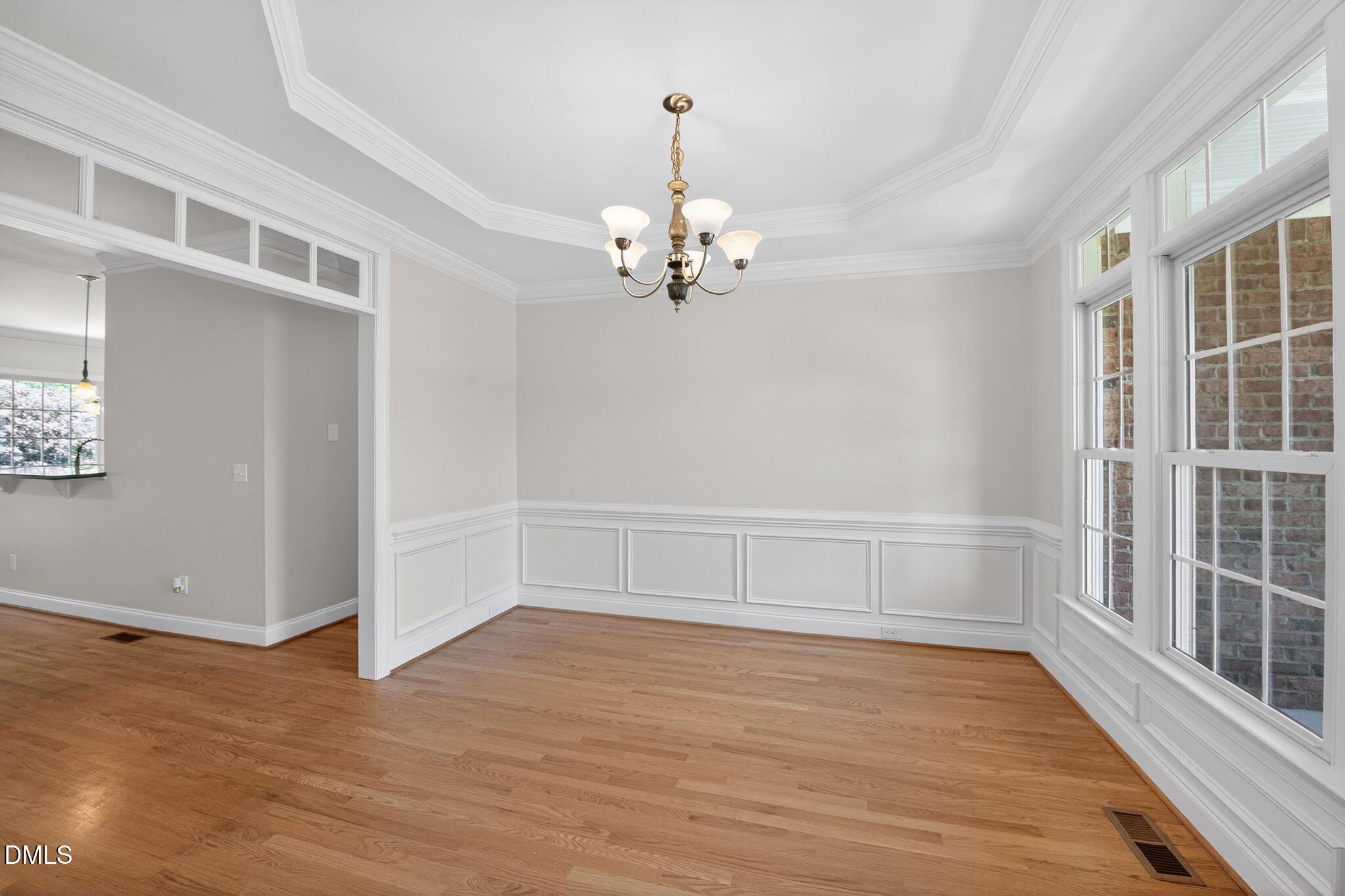 8725 Oregon Inlet Court Raleigh, NC 27603 - Photo 12 of 31 wooden floor in an empty room with a window