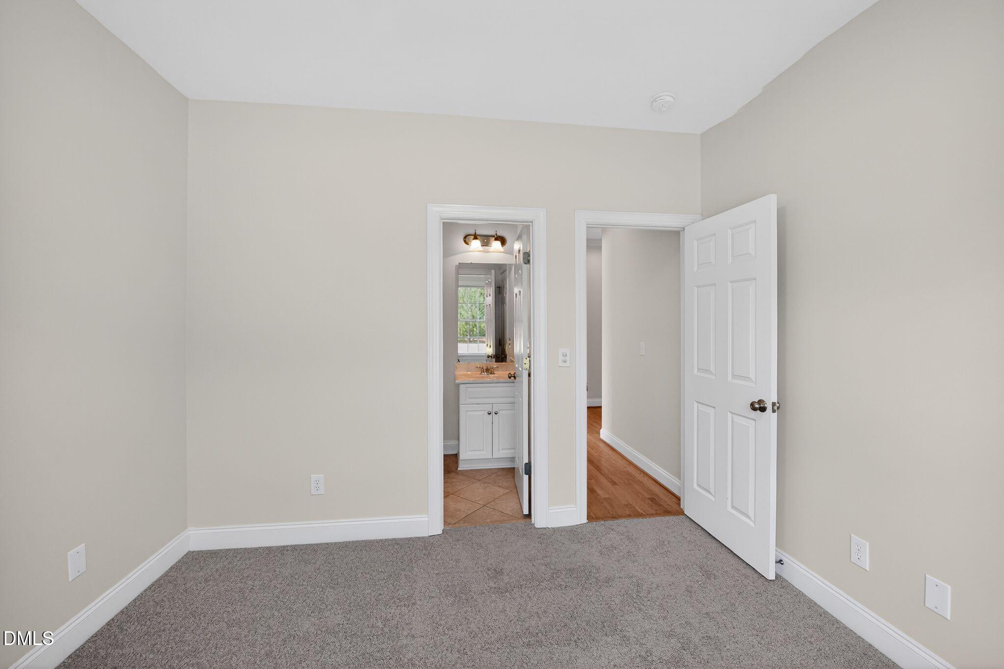 8725 Oregon Inlet Court Raleigh, NC 27603 - Photo 14 of 31 an empty room with closet and mirror