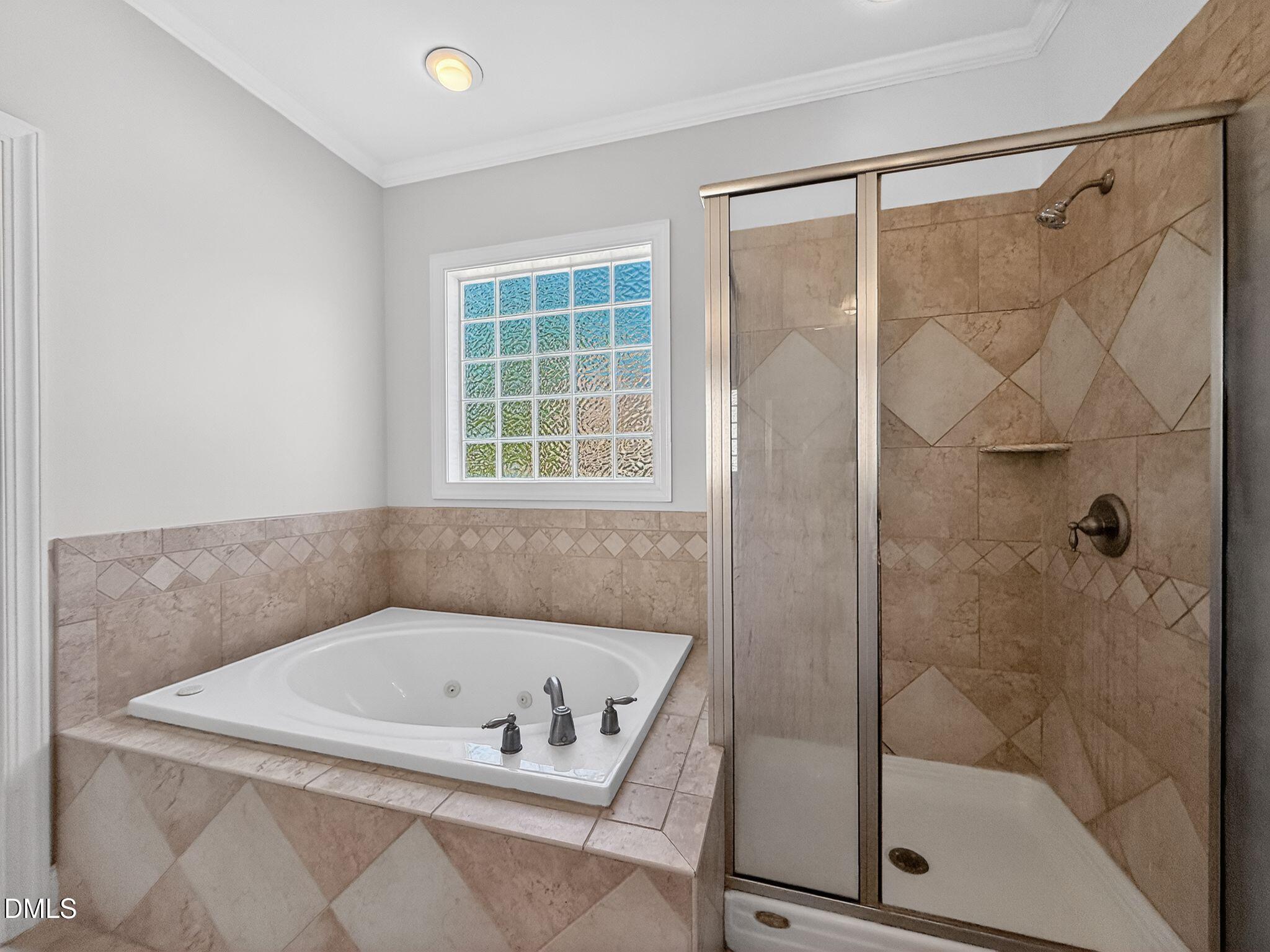8725 Oregon Inlet Court Raleigh, NC 27603 - Photo 20 of 31 a bathroom with a bath tub and a shower