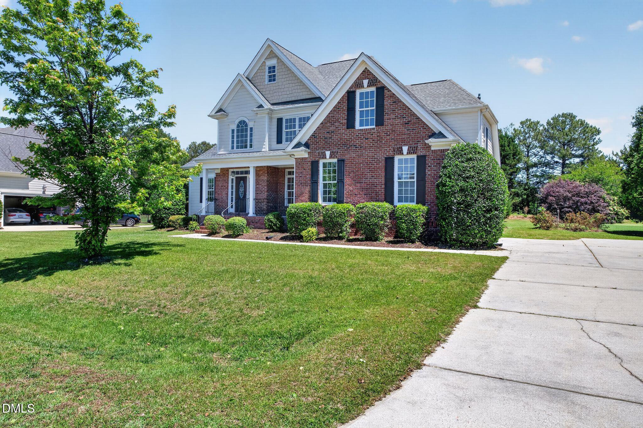 8725 Oregon Inlet Court Raleigh, NC 27603 - Photo 2 of 31 a front view of a house with a yard