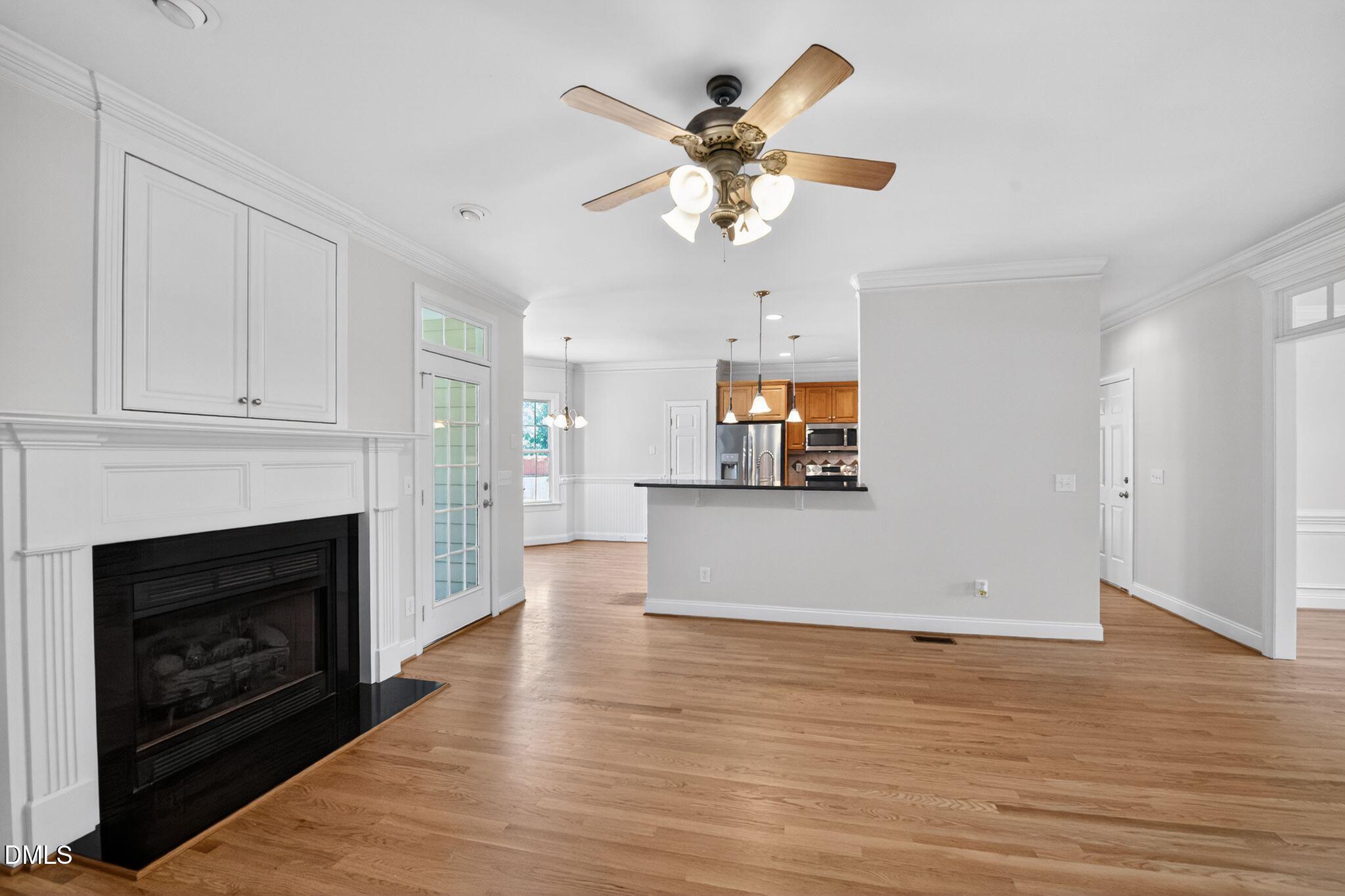 8725 Oregon Inlet Court Raleigh, NC 27603 - Photo 5 of 31 a view of empty room with wooden floor and fireplace