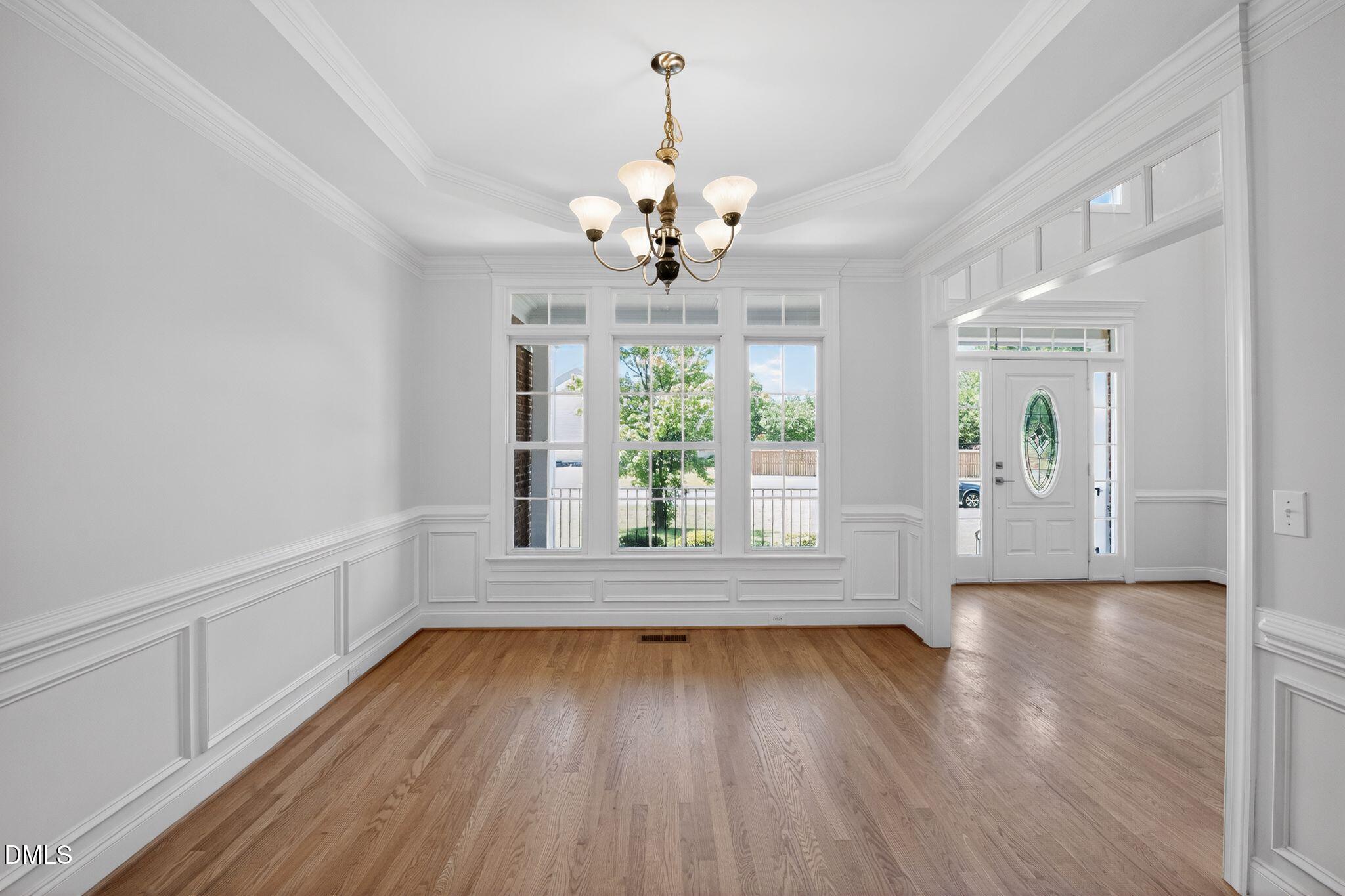8725 Oregon Inlet Court Raleigh, NC 27603 - Photo 7 of 31 a view of an empty room with wooden floor and a window