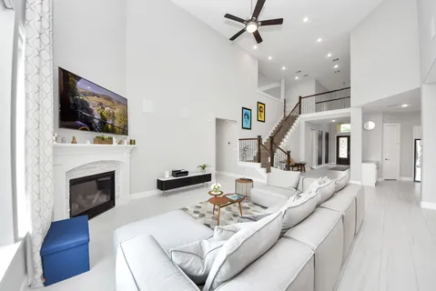 a living room with fireplace furniture and a flat screen tv