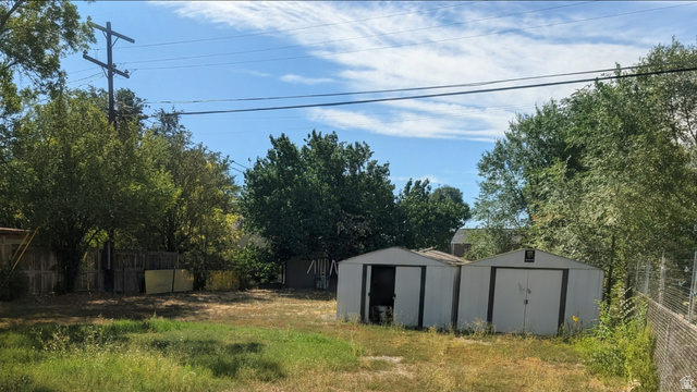 197 West Center Street Midvale, UT 84047 - Photo 3 of 12 Fenced yard featuring a shed