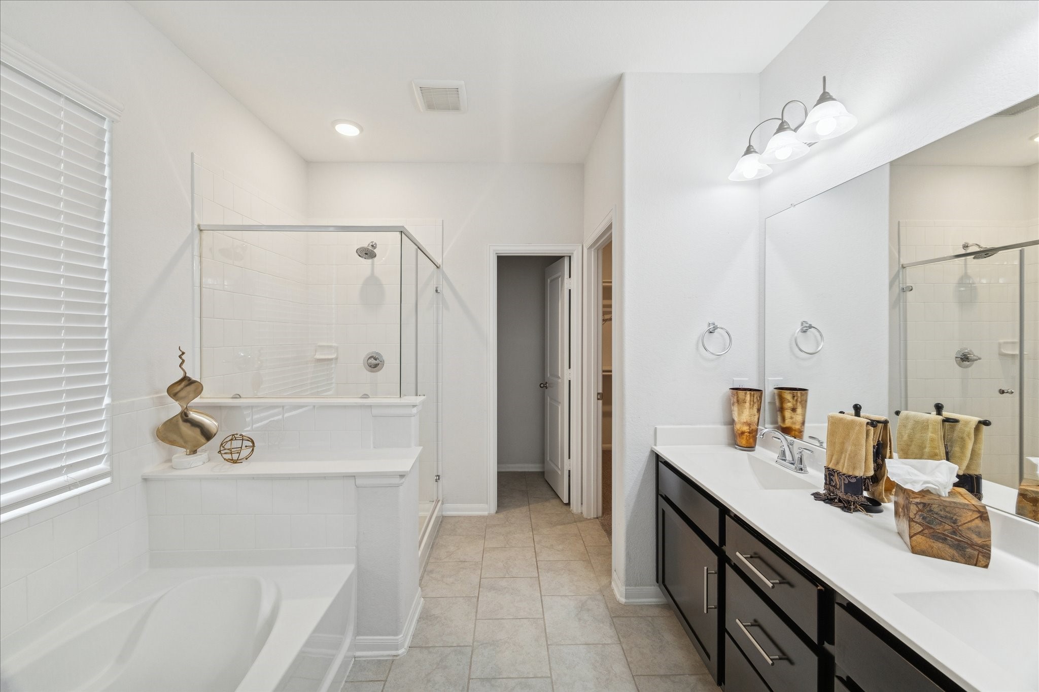 8818 Ruddy Duck Court Baytown, TX 77521 - Photo 21 of 38 A generously sized bathroom featuring double sinks, offering both comfort and convenience.