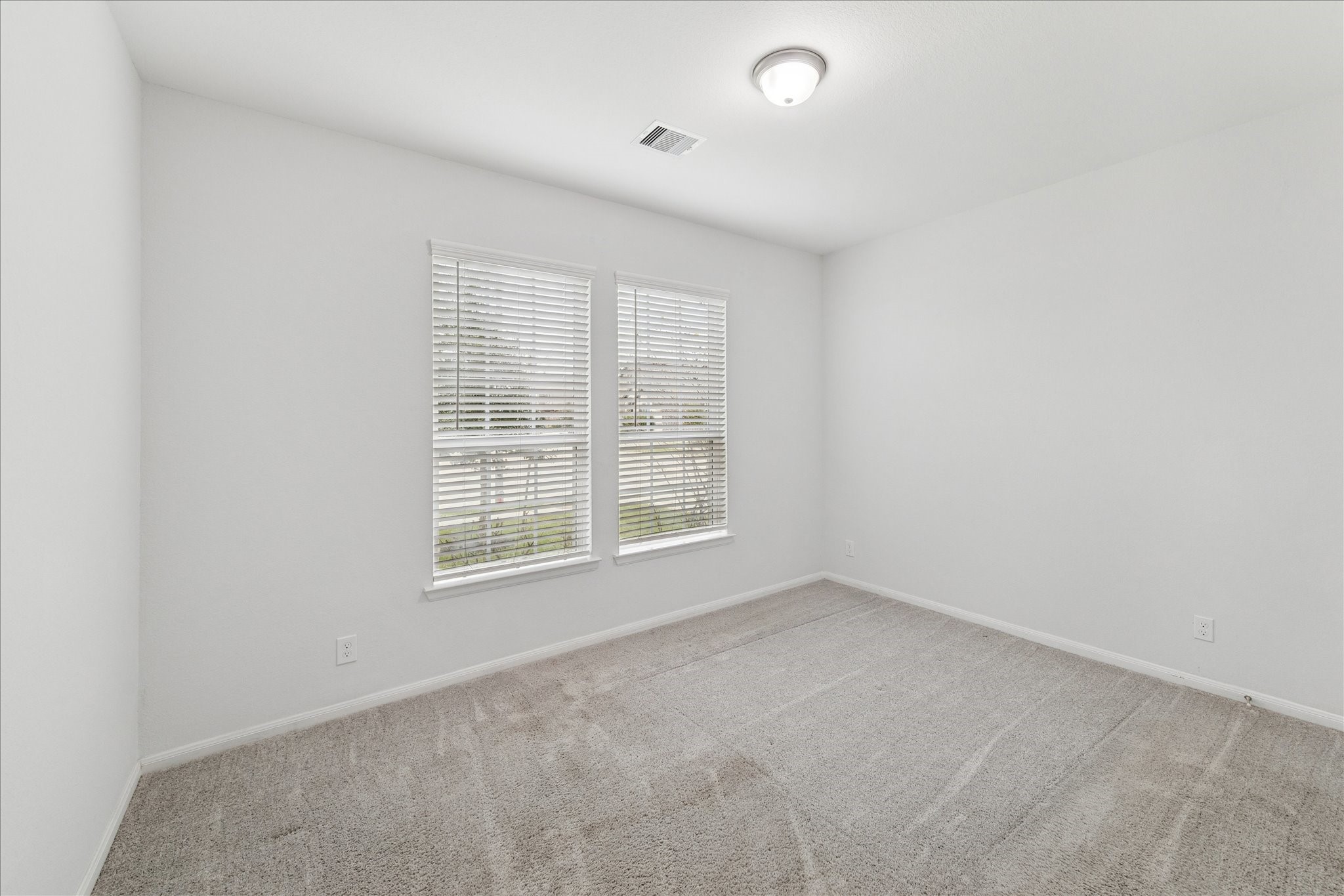 8818 Ruddy Duck Court Baytown, TX 77521 - Photo 27 of 38 The third bedroom offers a generous closet and two windows that bathe the space in natural light.
