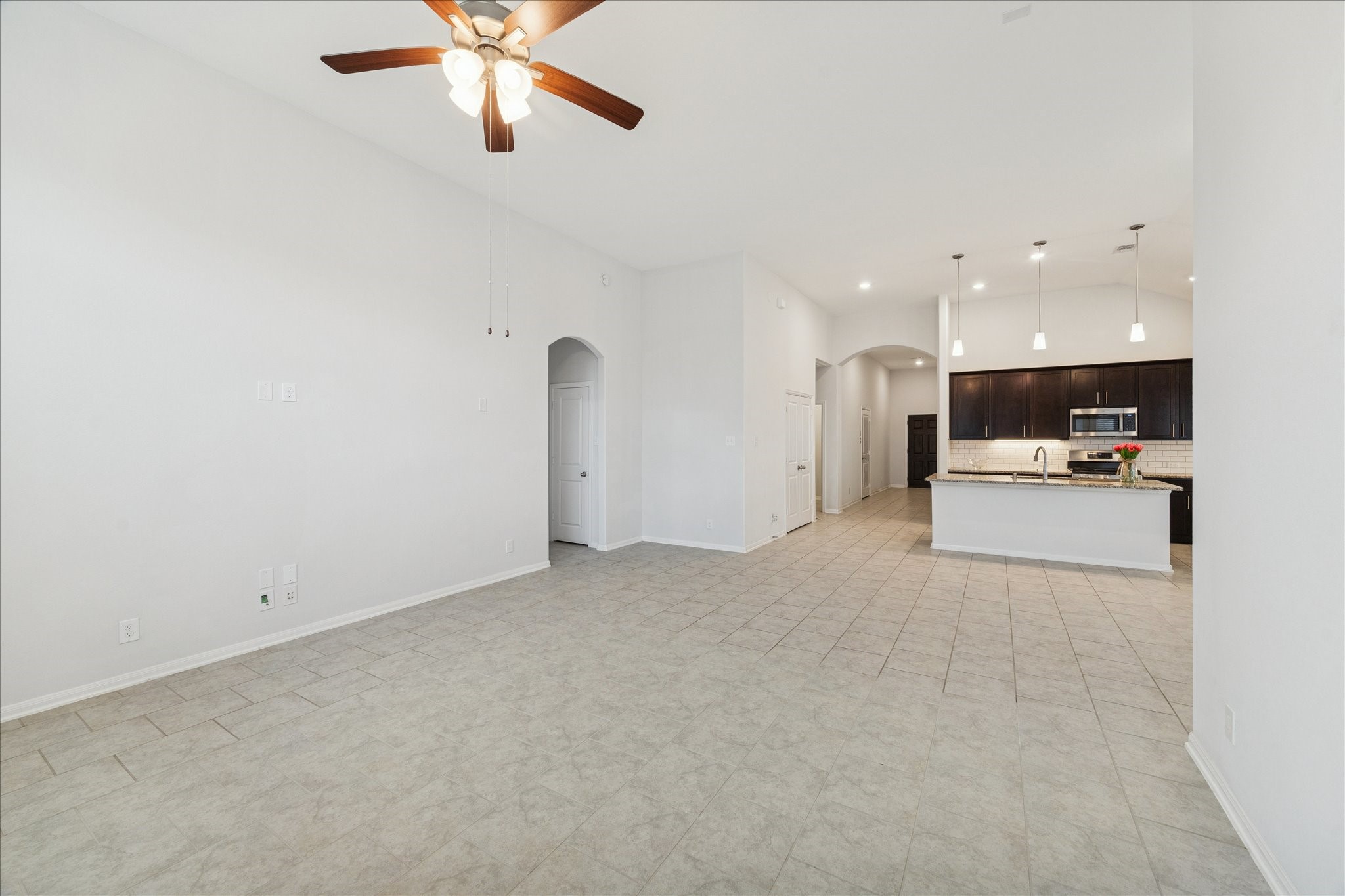 8818 Ruddy Duck Court Baytown, TX 77521 - Photo 8 of 38 Take a view of the family room, open-concept kitchen, and inviting entry, framed by elegant high ceilings.