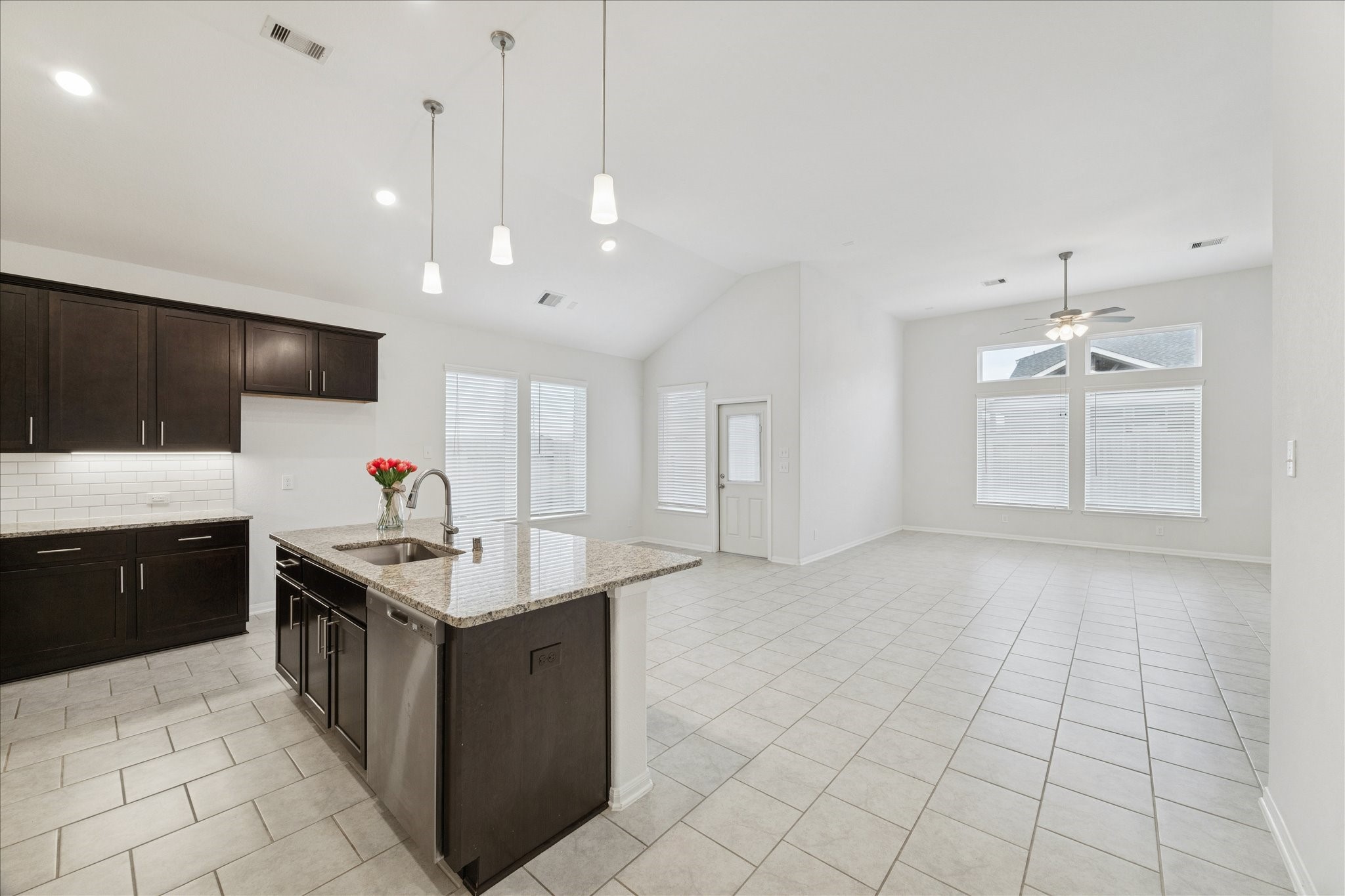 8818 Ruddy Duck Court Baytown, TX 77521 - Photo 9 of 38 A stunning kitchen showcasing granite countertops and a beautifully designed open area.
