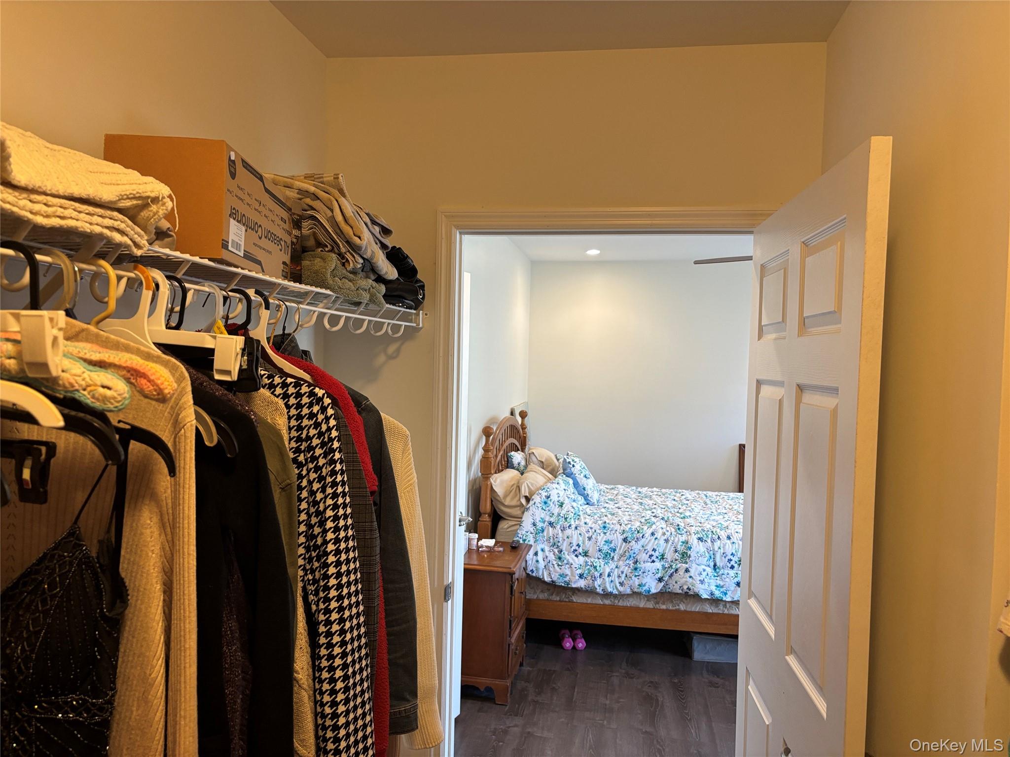 1661 Old Country Road, Unit 563 Riverhead, NY 11901 - Photo 35 of 43 a view of walk in closet with clothes and shoes