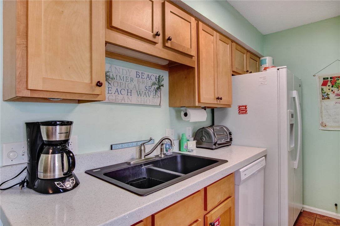 2745 Forest Ridge Drive, Unit I5 Fernandina Beach, FL 32034 - Photo 11 of 32 a kitchen with refrigerator and cabinets