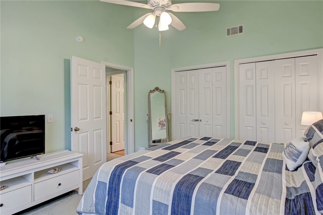 2745 Forest Ridge Drive, Unit I5 Fernandina Beach, FL 32034 - Photo 14 of 32 a bedroom with a bed and a flat tv screen on dresser
