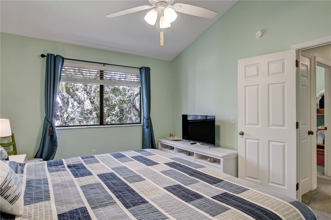 2745 Forest Ridge Drive, Unit I5 Fernandina Beach, FL 32034 - Photo 15 of 32 a bedroom with a bed and a flat screen tv