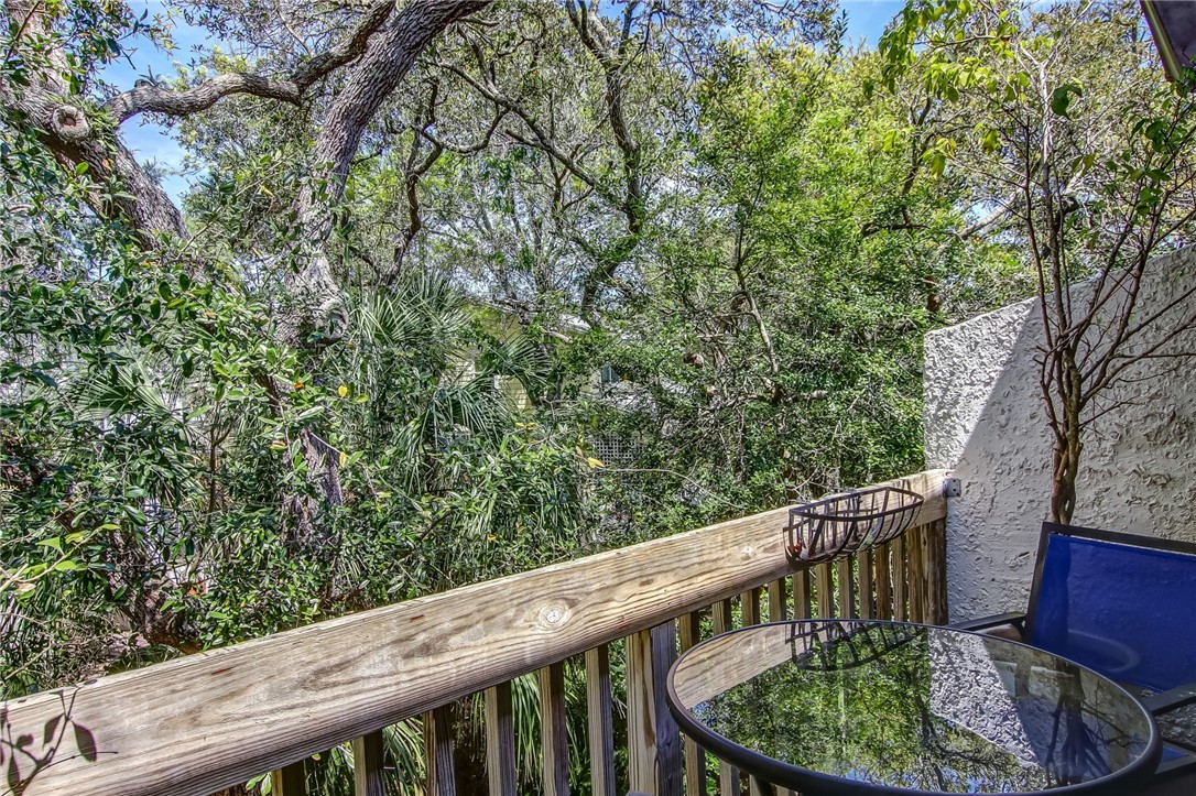 2745 Forest Ridge Drive, Unit I5 Fernandina Beach, FL 32034 - Photo 21 of 32 a balcony with wooden fence and trees