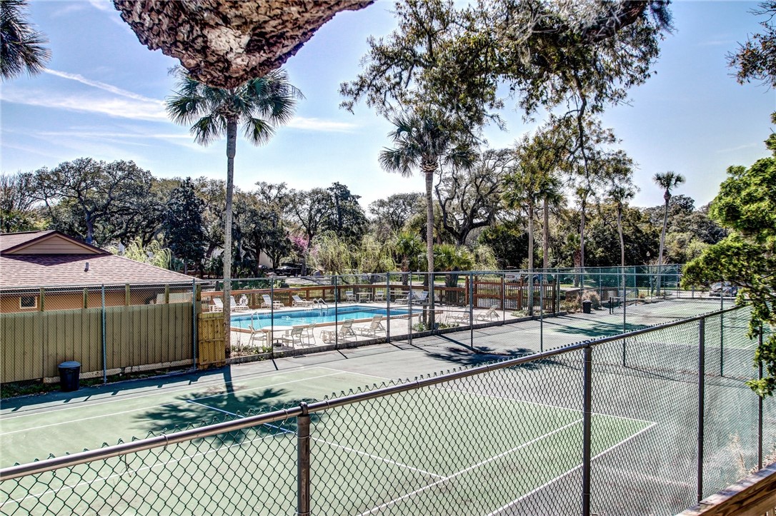 2745 Forest Ridge Drive, Unit I5 Fernandina Beach, FL 32034 - Photo 28 of 32 a view of a tennis court with palm trees