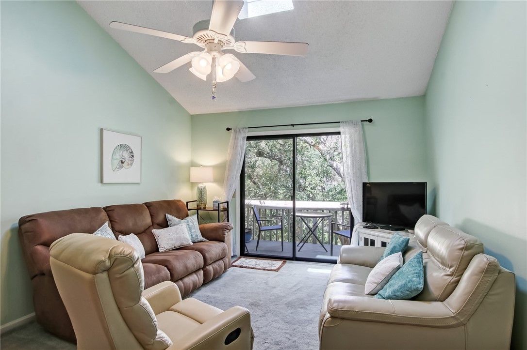2745 Forest Ridge Drive, Unit I5 Fernandina Beach, FL 32034 - Photo 4 of 32 a living room with furniture a flat screen tv and a large window