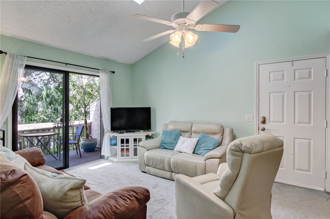 2745 Forest Ridge Drive, Unit I5 Fernandina Beach, FL 32034 - Photo 6 of 32 a living room with furniture a flat screen tv and a large window