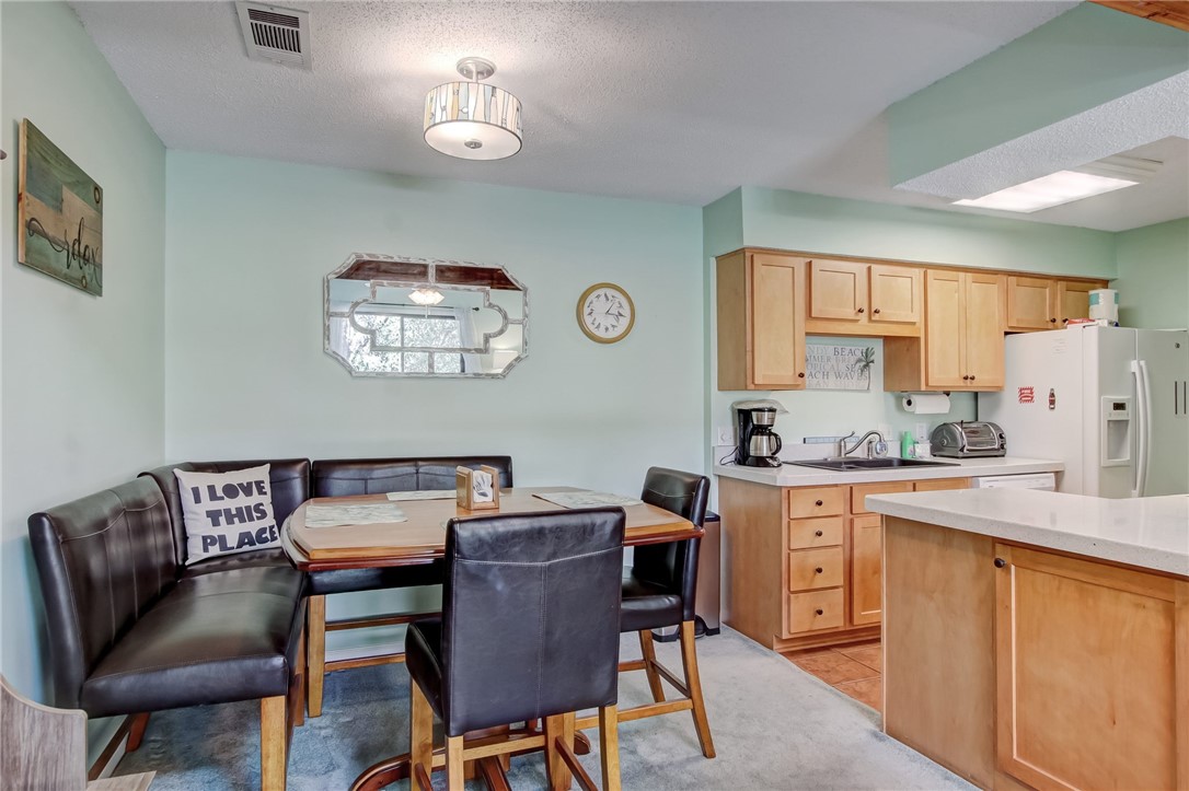 2745 Forest Ridge Drive, Unit I5 Fernandina Beach, FL 32034 - Photo 8 of 32 a view of a dining room with furniture window and wooden floor