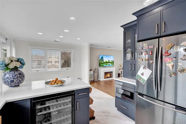a kitchen with stainless steel appliances granite countertop a sink and wooden floor