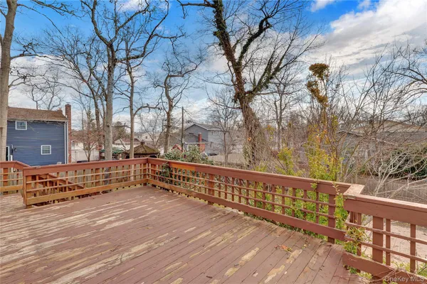 a view of a balcony with wooden fence and floor