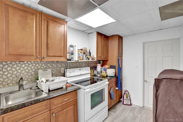 a kitchen with stainless steel appliances granite countertop a sink stove and cabinets