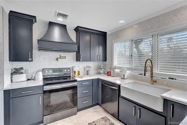 a kitchen with a sink stove and cabinets