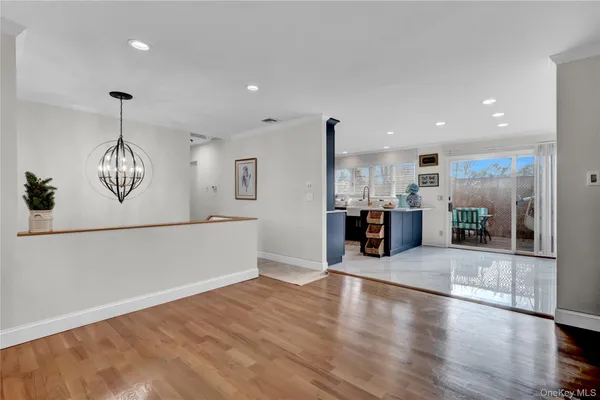 a view of a kitchen with furniture and wooden floor
