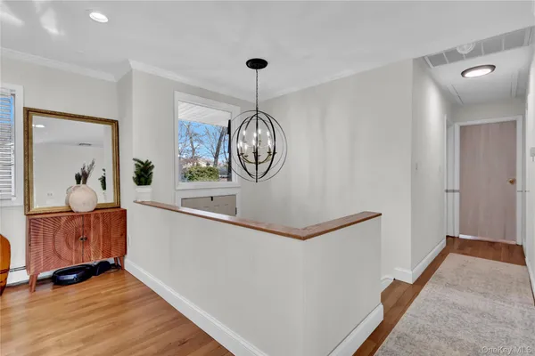 a view of a hallway with entryway wooden floor and front door