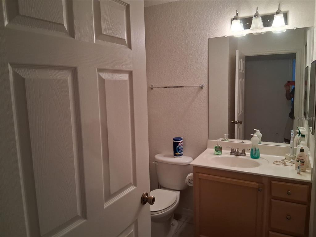 2763 Lighthouse Cove Road, Unit 6204 Orange City, FL 32763 - Photo 12 of 15 a bathroom with a sink vanity mirror and toilet