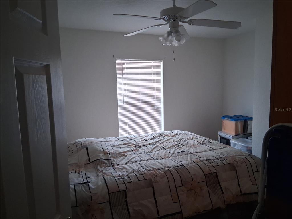 2763 Lighthouse Cove Road, Unit 6204 Orange City, FL 32763 - Photo 13 of 15 a bedroom with a bed and a table