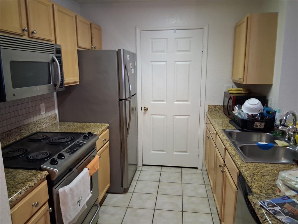 2763 Lighthouse Cove Road, Unit 6204 Orange City, FL 32763 - Photo 4 of 15 a kitchen with a stove and a refrigerator