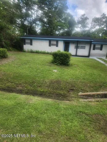 a front view of house with yard and green space