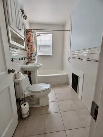 a bathroom with a sink toilet and tub