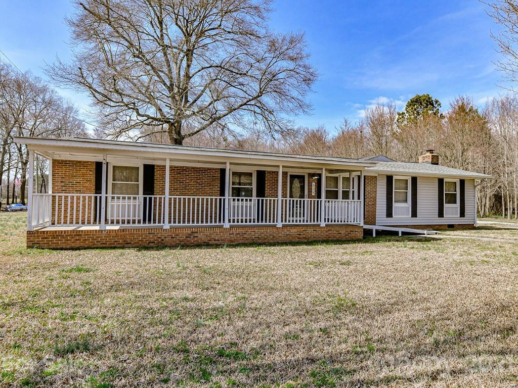 515 Sikes Mill Road Monroe, NC 28110 - Photo 1 of 33 a view of a house with a large window and wooden fence