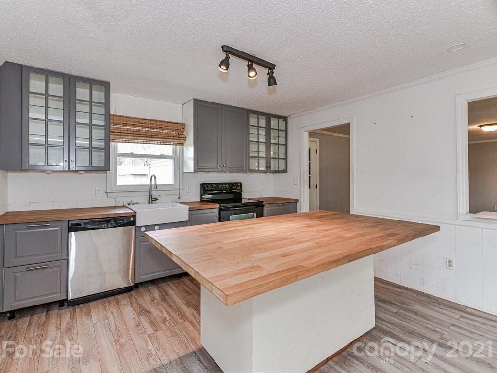 515 Sikes Mill Road Monroe, NC 28110 - Photo 11 of 33 a kitchen with stainless steel appliances granite countertop a stove a sink and a refrigerator