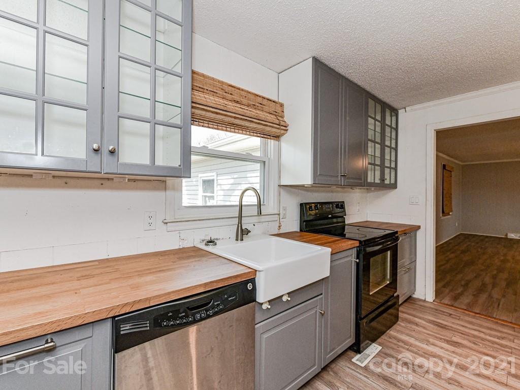 515 Sikes Mill Road Monroe, NC 28110 - Photo 12 of 33 a kitchen with a stove and a sink